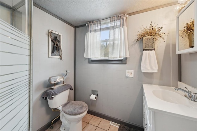 bathroom with vanity, tile patterned flooring, a textured ceiling, toilet, and visible vents