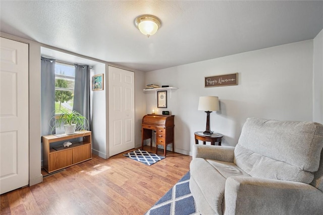 living area with baseboards and light wood-style floors