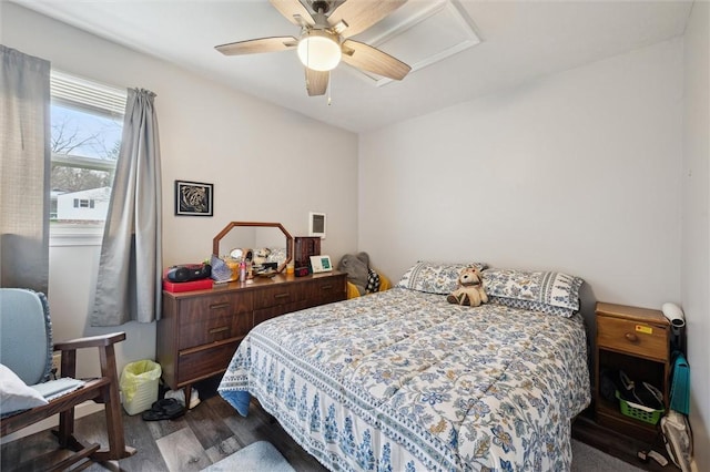 bedroom with ceiling fan and dark wood finished floors