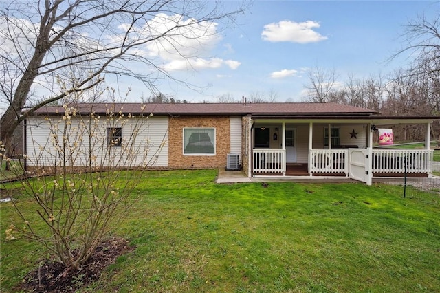 rear view of property with a lawn and covered porch