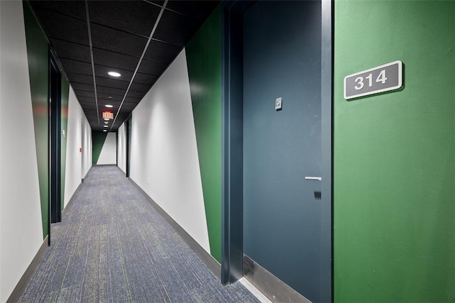 hallway with dark colored carpet and recessed lighting