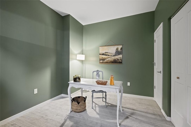 carpeted office space featuring baseboards
