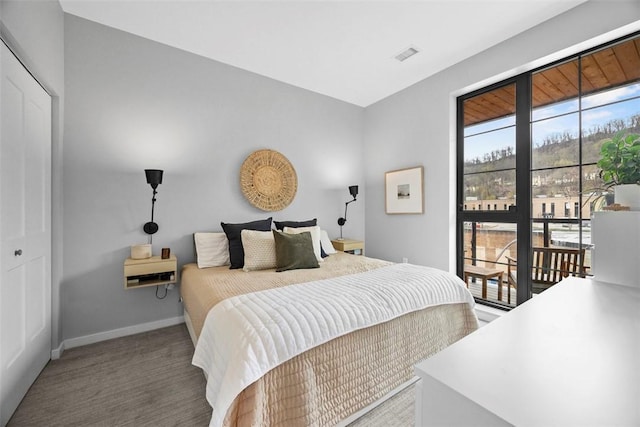 carpeted bedroom featuring baseboards and visible vents