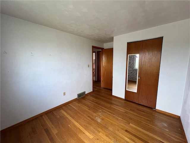 546 Center Hill Dr, Plum Boro, PA 15239 - unfurnished bedroom featuring visible vents, baseboards, a closet, and wood finished floors