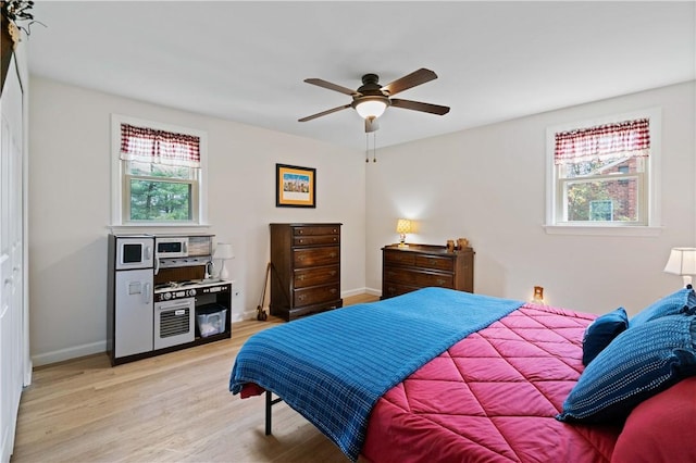 1171 Fox Terrier Dr, Bethel Park, PA 15102 - bedroom with light wood-style flooring, a ceiling fan, and baseboards
