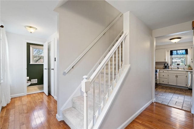 1171 Fox Terrier Dr, Bethel Park, PA 15102 - stairs with plenty of natural light, wood-type flooring, and baseboards