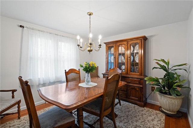1171 Fox Terrier Dr, Bethel Park, PA 15102 - dining area featuring a notable chandelier, light wood-type flooring, and baseboards