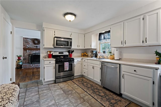 1171 Fox Terrier Dr, Bethel Park, PA 15102 - kitchen featuring white cabinetry, light countertops, and appliances with stainless steel finishes