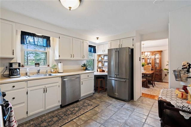 1171 Fox Terrier Dr, Bethel Park, PA 15102 - kitchen featuring white cabinets, a sink, light countertops, stainless steel appliances, and stone finish flooring