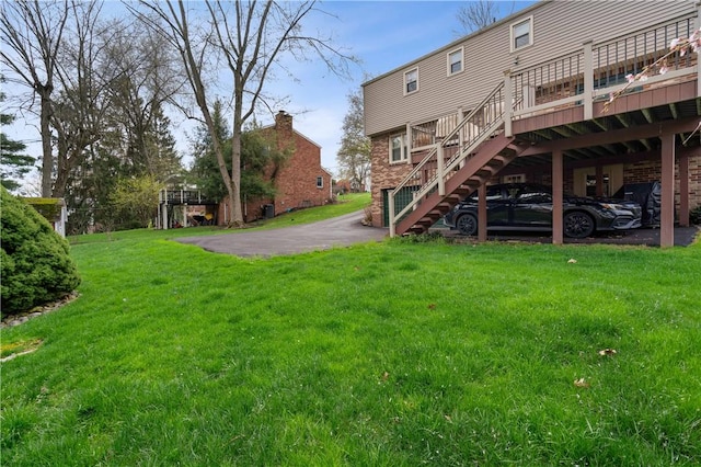 1171 Fox Terrier Dr, Bethel Park, PA 15102 - back of property featuring brick siding, a deck, a lawn, and stairs