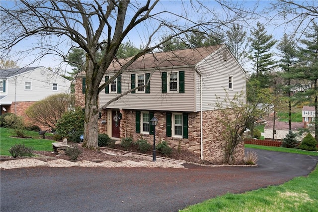 1171 Fox Terrier Dr, Bethel Park, PA 15102 - colonial home featuring a chimney, aphalt driveway, and brick siding