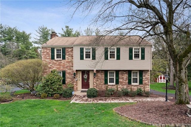 1171 Fox Terrier Dr, Bethel Park, PA 15102 - colonial home featuring a front yard, brick siding, and a chimney