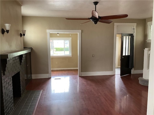 913 Russellwood Ave, Mckees Rocks, PA 15136 - unfurnished living room with dark wood-type flooring, ceiling fan, a brick fireplace, and baseboards