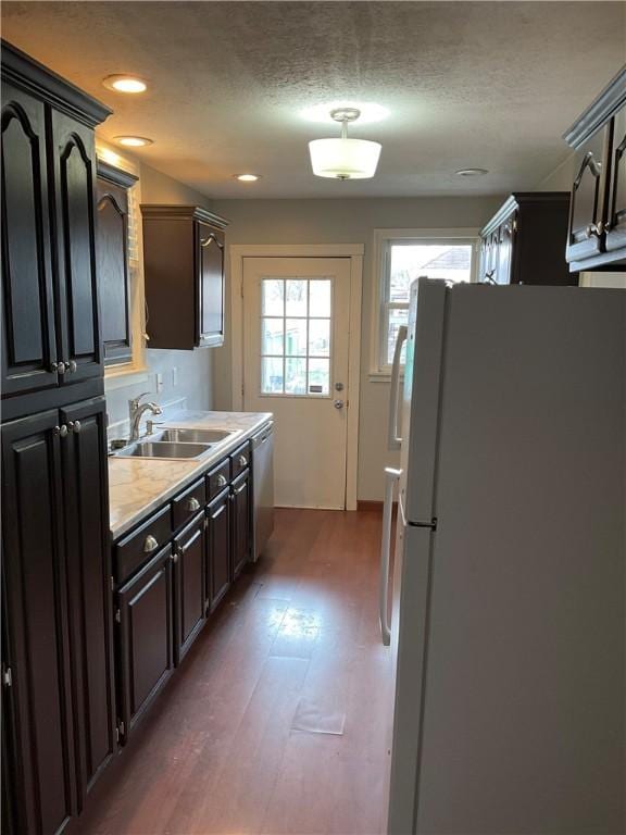913 Russellwood Ave, Mckees Rocks, PA 15136 - kitchen featuring freestanding refrigerator, wood finished floors, dishwasher, light countertops, and a sink