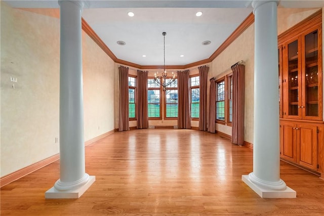422 Heights Dr, Pine Twp Nal, PA 15044 - unfurnished dining area featuring decorative columns, light wood-type flooring, and a chandelier