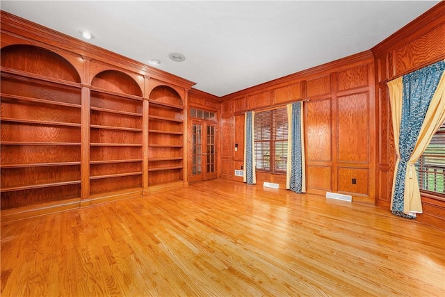 422 Heights Dr, Pine Twp Nal, PA 15044 - empty room featuring light wood finished floors, visible vents, wooden walls, and built in shelves