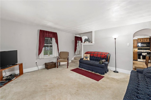 313 N Market St, Carmichaels/Cumblnd, PA 15320 - living room with arched walkways, light colored carpet, and baseboards