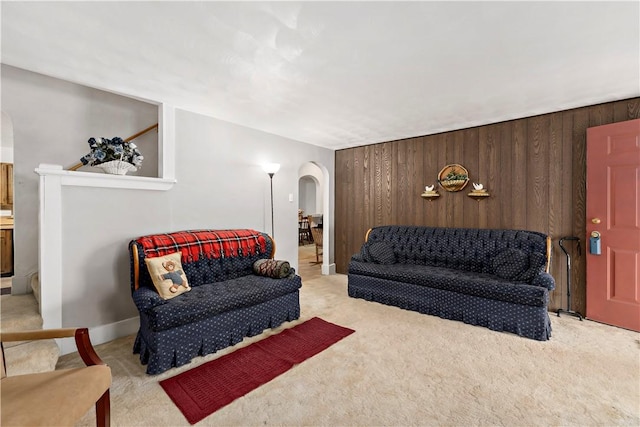 313 N Market St, Carmichaels/Cumblnd, PA 15320 - living area featuring wood walls, arched walkways, and carpet floors
