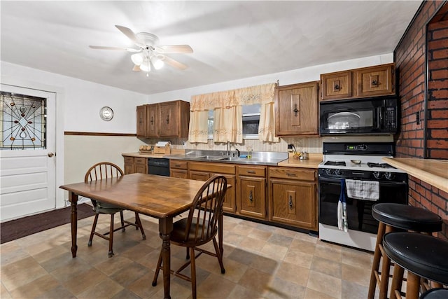 313 N Market St, Carmichaels/Cumblnd, PA 15320 - kitchen with light countertops, a ceiling fan, backsplash, black appliances, and a sink