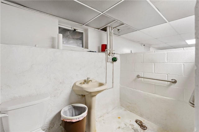 313 N Market St, Carmichaels/Cumblnd, PA 15320 - bathroom with toilet, concrete block wall, a paneled ceiling, and walk in shower