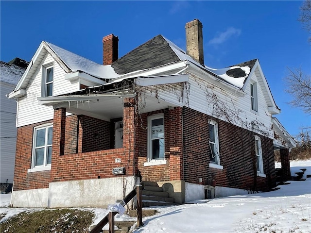 846 Florence Ave, East Mckeesport, PA 15035 - snow covered property with a chimney and brick siding