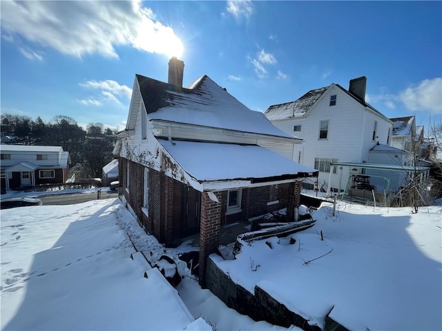 846 Florence Ave, East Mckeesport, PA 15035 - view of snowy exterior with a chimney