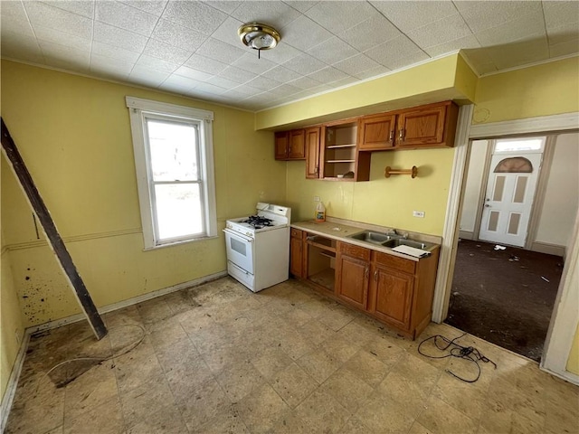 846 Florence Ave, East Mckeesport, PA 15035 - kitchen with open shelves, a sink, gas range gas stove, brown cabinetry, and light floors