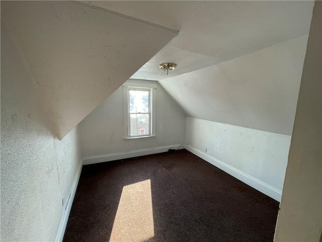 846 Florence Ave, East Mckeesport, PA 15035 - additional living space featuring dark colored carpet, baseboards, a textured ceiling, and lofted ceiling
