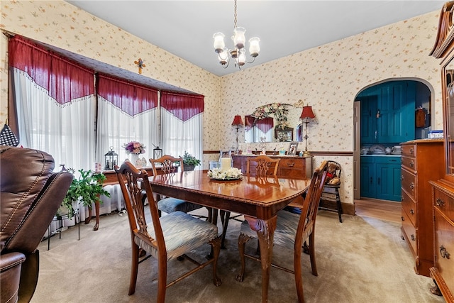 16 Elm St, Burgettstown Boro, PA 15021 - dining space with a notable chandelier, light colored carpet, wallpapered walls, and wainscoting