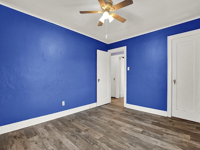unfurnished bedroom with ceiling fan, baseboards, crown molding, and wood finished floors