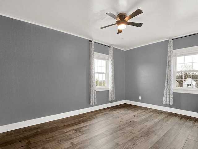 unfurnished room featuring wood finished floors, ceiling fan, baseboards, and ornamental molding