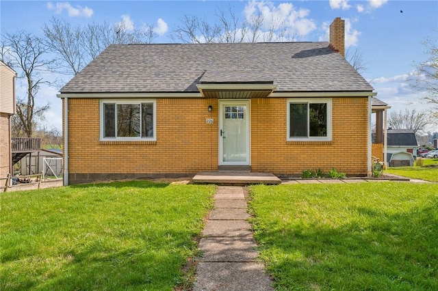 226 Old Leechburg Rd, Plum Boro, PA 15239 - bungalow-style home with roof with shingles, brick siding, a chimney, and a front lawn