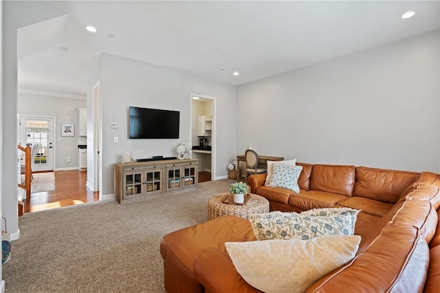living room featuring recessed lighting, baseboards, and carpet floors
