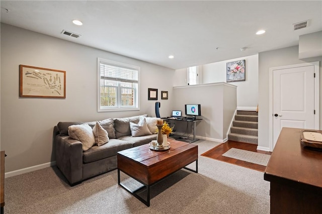 carpeted living room with recessed lighting, visible vents, and baseboards