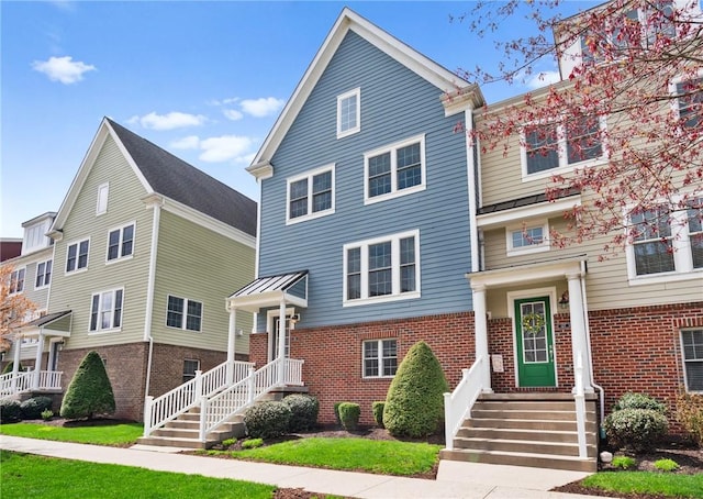 townhome / multi-family property featuring brick siding
