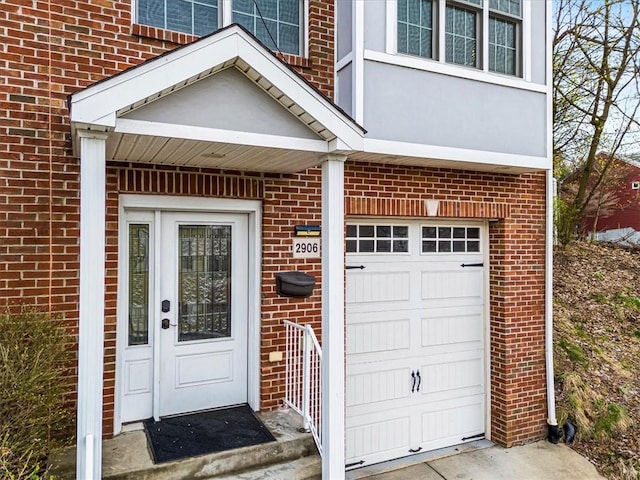 doorway to property with brick siding