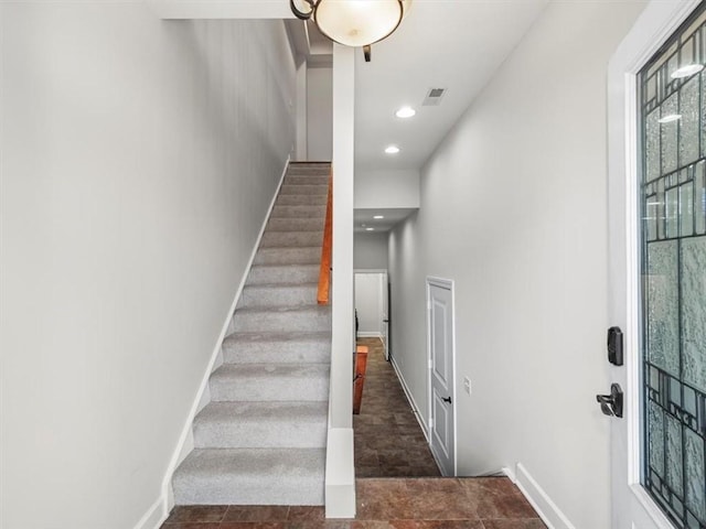 stairs featuring baseboards, visible vents, and recessed lighting