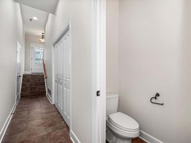 bathroom featuring visible vents, toilet, tile patterned flooring, and baseboards