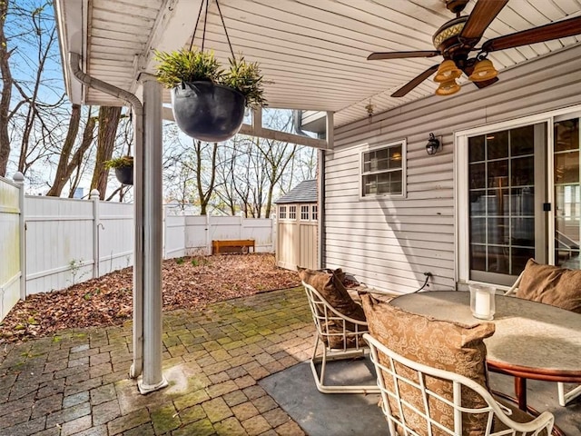 view of patio / terrace with outdoor dining area, a fenced backyard, and ceiling fan
