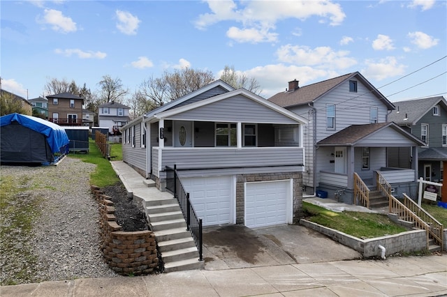 view of front of home featuring a garage, stairway, stone siding, and concrete driveway