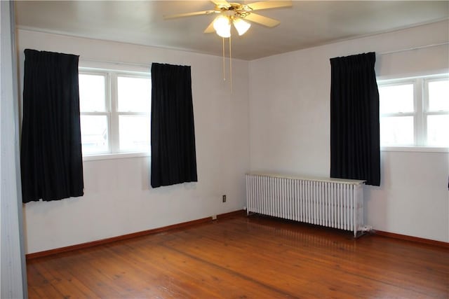 607 River St, W Brownsville, PA 15417 - spare room featuring radiator, wood-type flooring, baseboards, and a healthy amount of sunlight