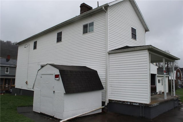 607 River St, W Brownsville, PA 15417 - back of property with a storage shed, an outbuilding, and a chimney