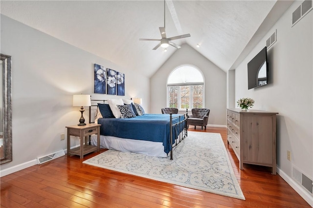 bedroom with wood-type flooring, visible vents, baseboards, and vaulted ceiling
