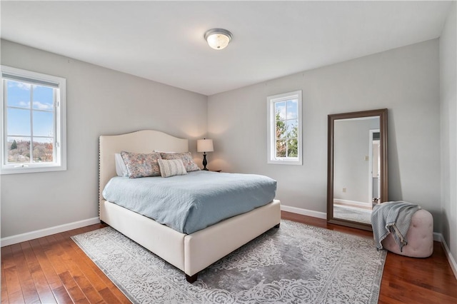 bedroom featuring hardwood / wood-style floors and baseboards