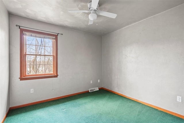 unfurnished room featuring visible vents, ceiling fan, carpet floors, and baseboards