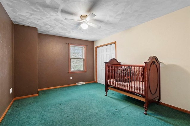 carpeted bedroom with a closet, ceiling fan, baseboards, and visible vents