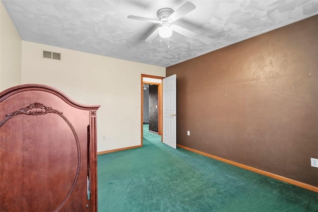 unfurnished bedroom featuring carpet flooring, visible vents, baseboards, and a ceiling fan