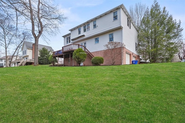 back of house featuring a yard, a garage, and stairs