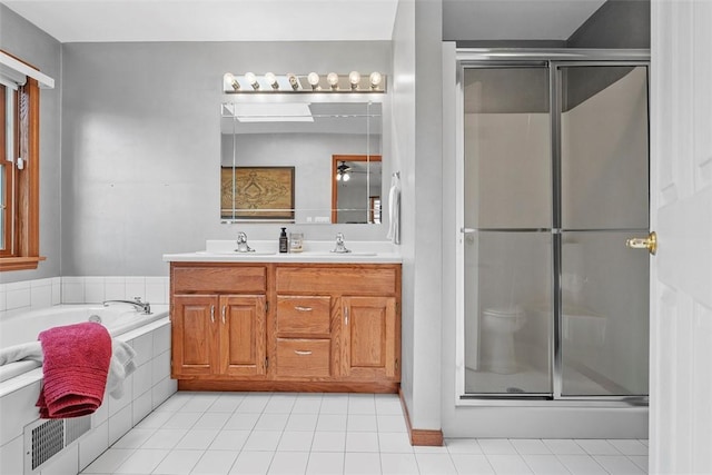 bathroom featuring a sink, a bath, double vanity, and a stall shower