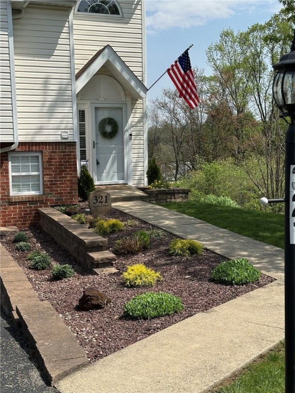 doorway to property with brick siding